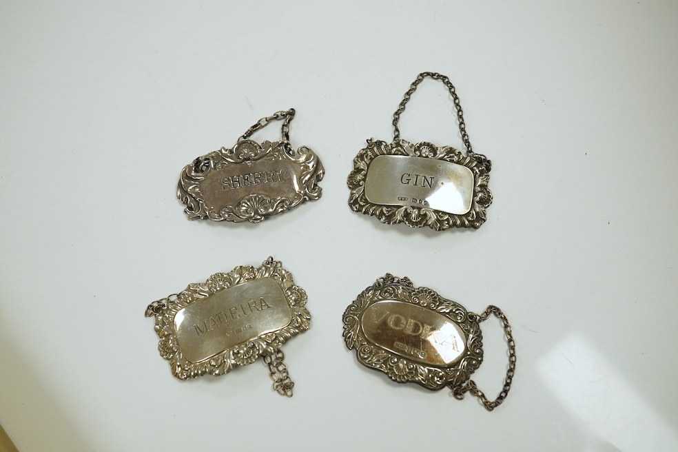 A collection of assorted silver wine labels, George III and later, 5.5oz, and two plated labels (19). Condition
